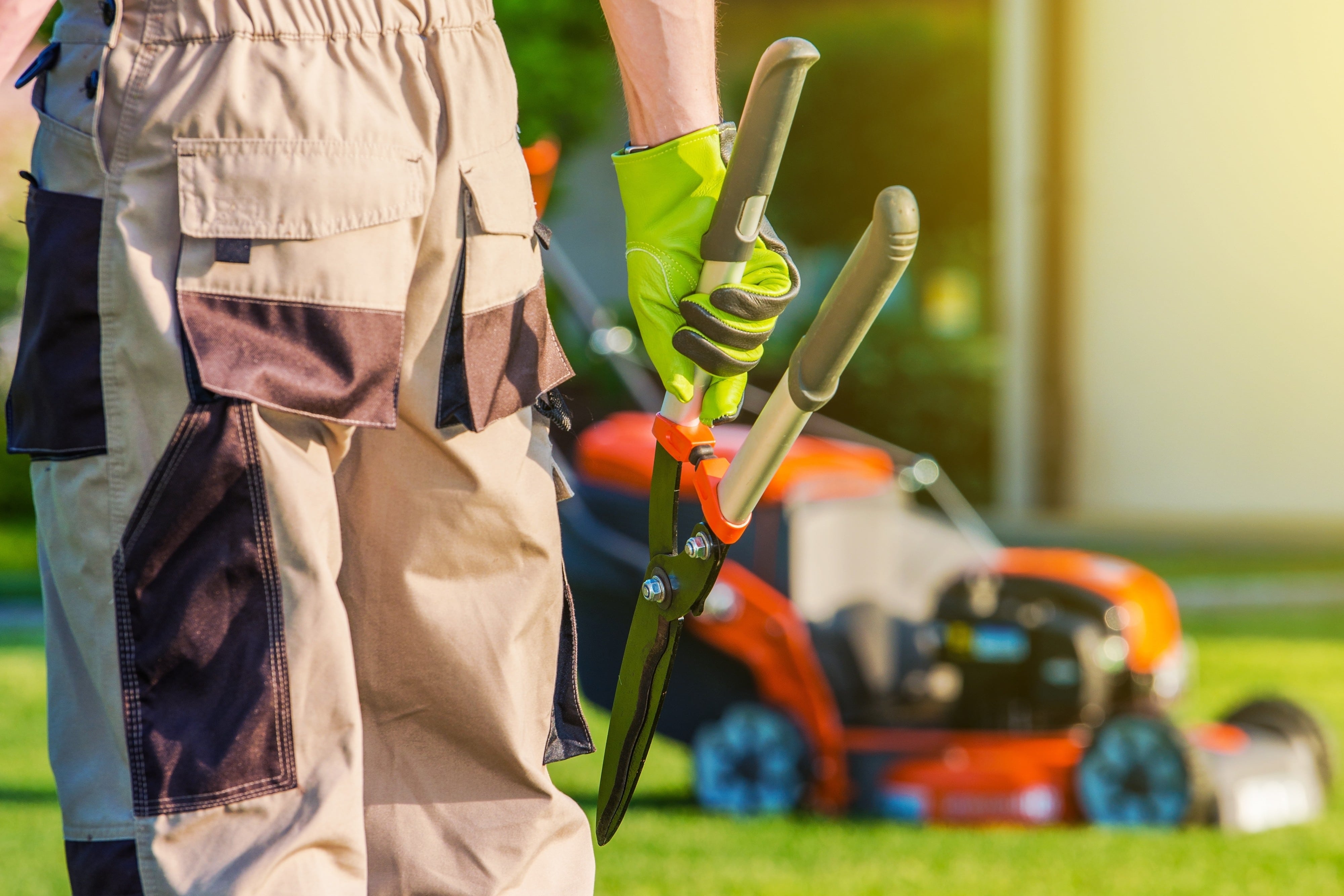 Gardener With Large Scissors And Other Gardening Equipment